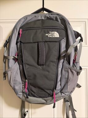 Like new North Face Surge Gray Backpack with Pink Accents